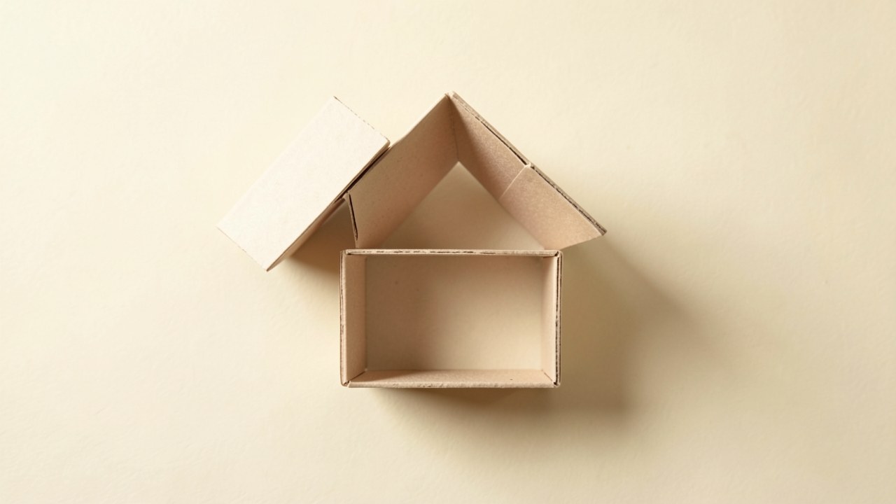 A small house of cards with one card tilting, symbolizing hidden financial risks.